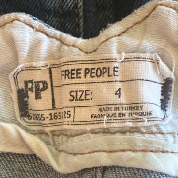 Free People distressed denim mini skirt with a buckle back and raw hem. - Picture 6 of 16